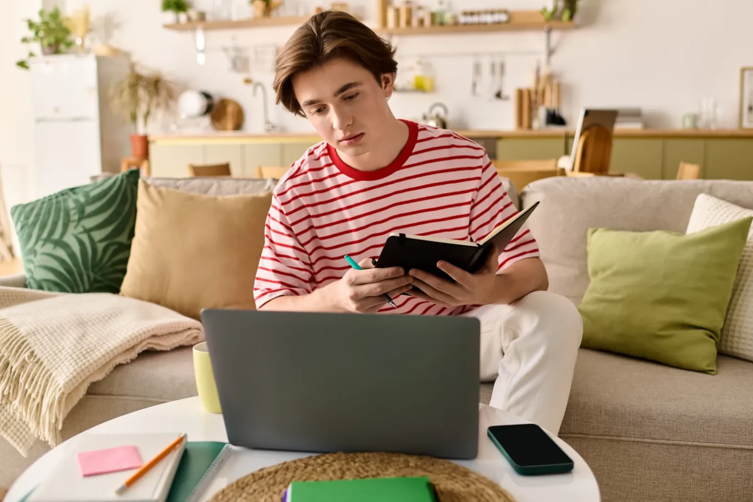 Online school cost guide: student studying at home with a laptop and notebook